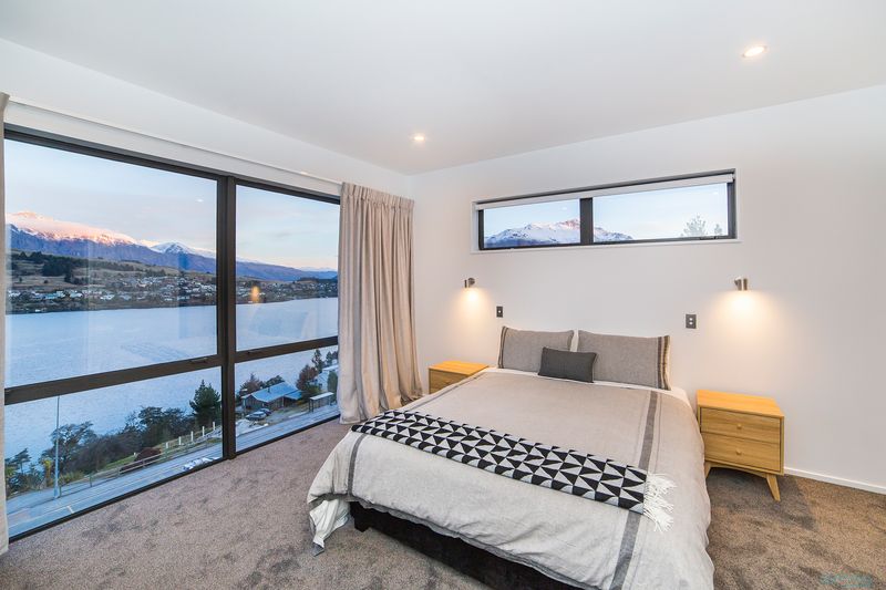 Upstairs master bedroom with panoramic views and luxury bedding